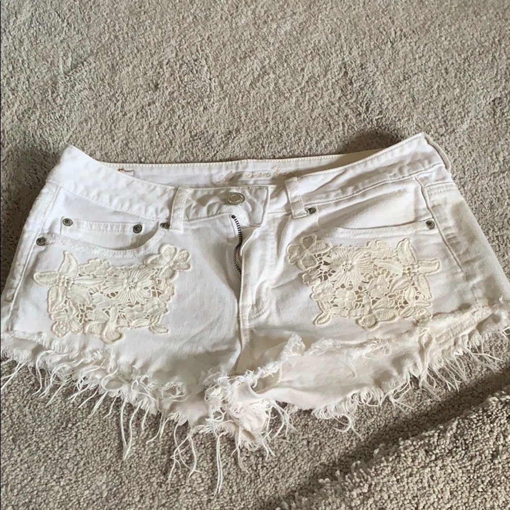 American eagle shorts with white flower accents